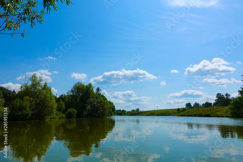 Lake with reflecting clouds. Summer time. Russia