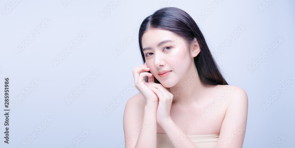 Beautiful Young asian Woman with Clean Fresh Skin look at camera. Girl beauty face care. Facial treatment. Cosmetology, beauty and spa Beautiful Young asian Woman with Clean Fresh Skin look at camera. Girl beauty face care. Facial treatment. Cosmetology, beauty and spa