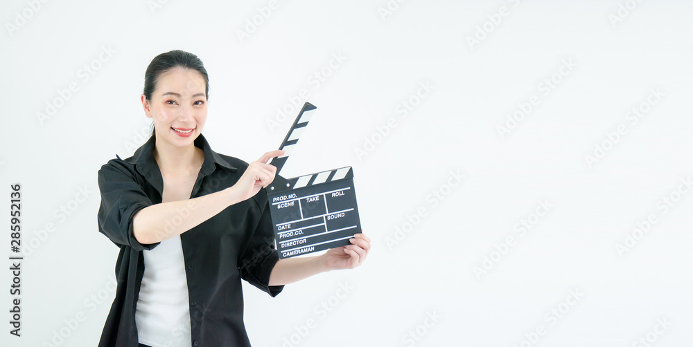 An attractive young asian woman holds an open film slate on white background.