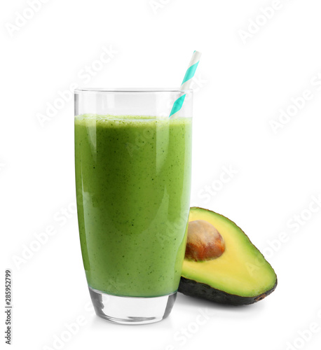Glass of tasty smoothie with straw and avocado on white background