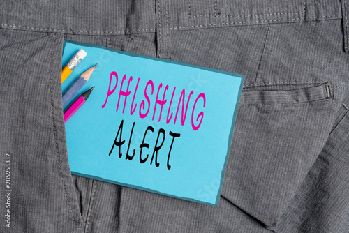 Conceptual hand writing showing Phishing Alert. Concept meaning aware to fraudulent attempt to obtain sensitive information Writing equipment and blue note paper in pocket of trousers