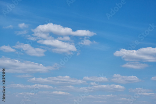 The sky on a Sunny summer day. Background clouds on blue sky. White Cumulus clouds in clear weather.