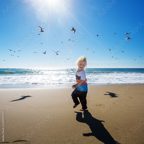 Photography Happy and free boy on the beach with seagulls