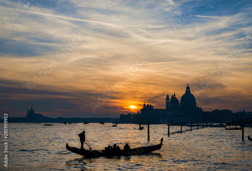 Beautiful romantic sunset over Venice Lagoon with gondola © crisfotolux