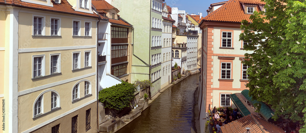 Street in the center of Prague near Charles bridge. Embankment of the Vltava river. Street in the center of Prague near Charles bridge. Embankment of the Vltava river.