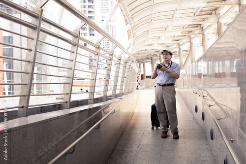 Wallpaper Mural Senior man dragging luggage in the airport to to travel. Torontodigital.ca
