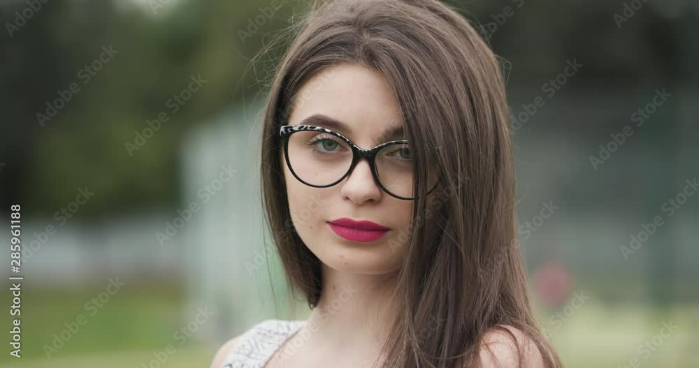 Pretty stylish woman in modern sunglasses outside looking at camera in the city summer. Businesswoman. Fashion lifestyle casual clothes Pretty stylish woman in modern sunglasses outside looking at camera in the city summer. Businesswoman. Fashion lifestyle casual clothes