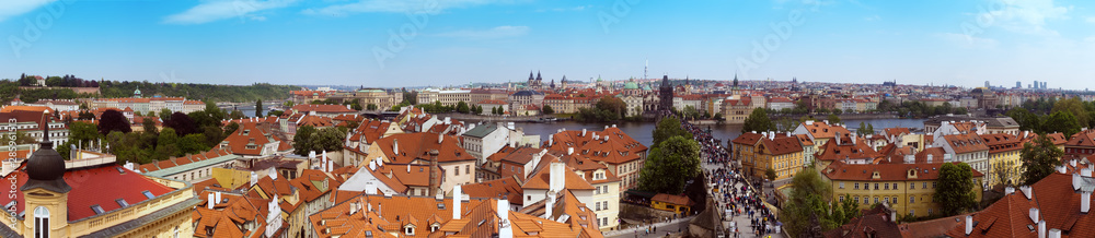 Beautiful panorama of Charles bridge (Karluv Most), Vltava river and red roofs from the Bridge Tower
