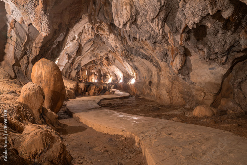 Photo pathway underground cave in Laos, with stalagmites and stalactites