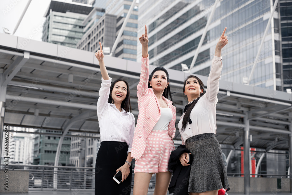 Group of asian business woman pointing forward with a smile. Group of asian business woman pointing forward with a smile.
