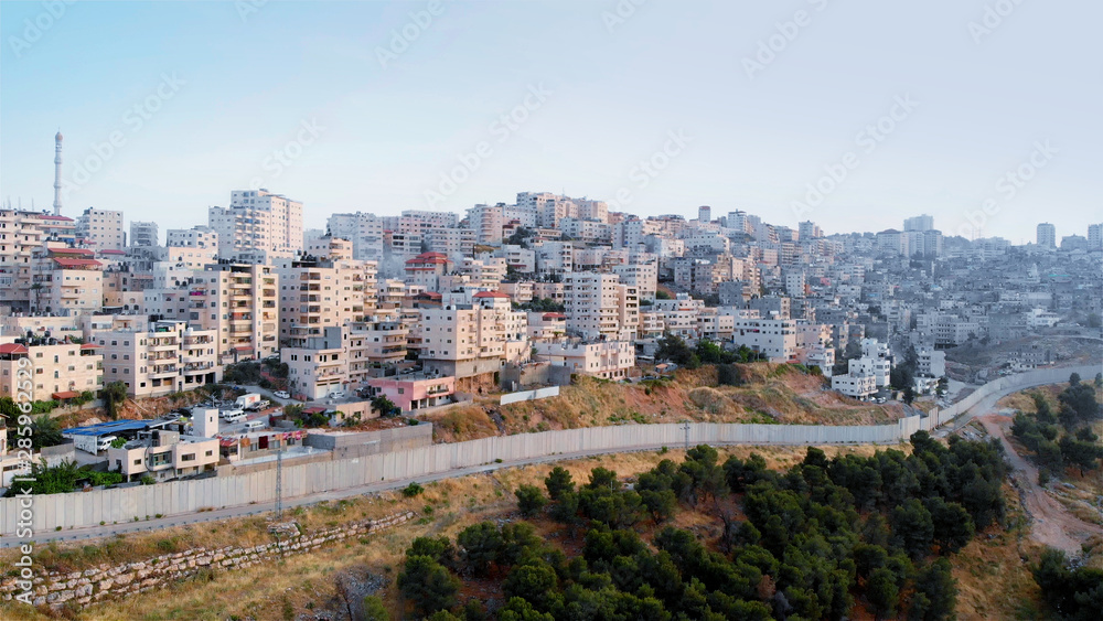 Palestinian Town Behind concrete Wall Aerial view Flying over Palestinian Town Shuafat Close to Jerusalem Drone footage 