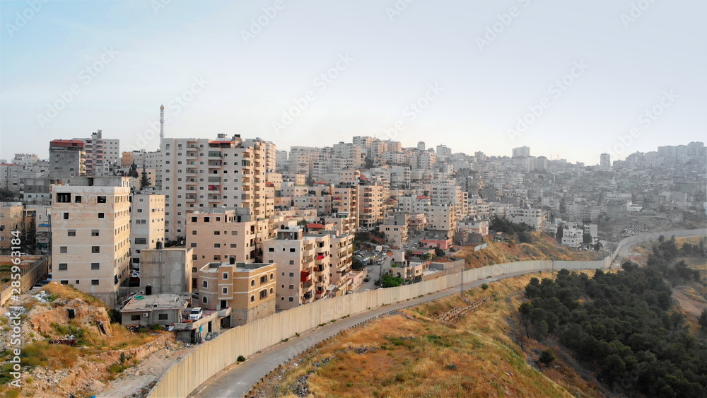 Palestinian Town Behind concrete Wall Aerial view Flying over Palestinian Town Shuafat Close to Jerusalem Drone footage 