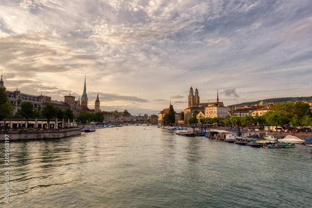 Panoramic view of historic Zurich downtown with Fraumunster and Grossmunster churches at lake zurich during sunset, Switzerland.