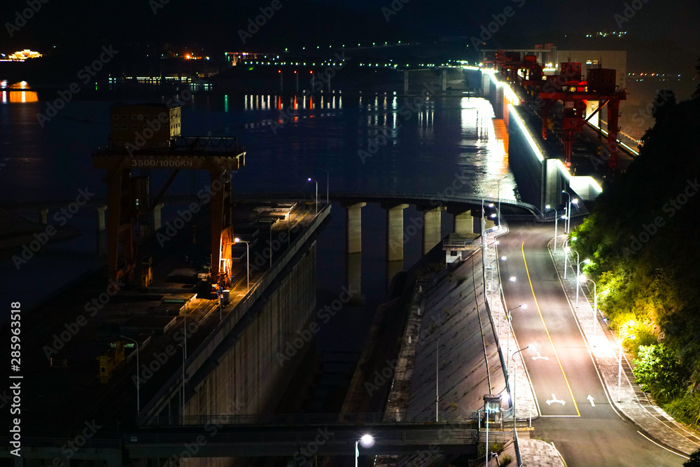 Three Gorges Dam at night - view from above looking down on the bridge of the massive hydro electric structure in China