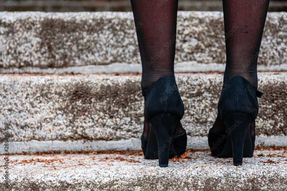 Feet of a woman wearing high heeled black shoes Feet of a woman wearing high heeled black shoes