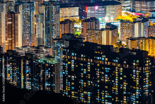 The night light of the condominium building In Hong Kong, China © chokniti