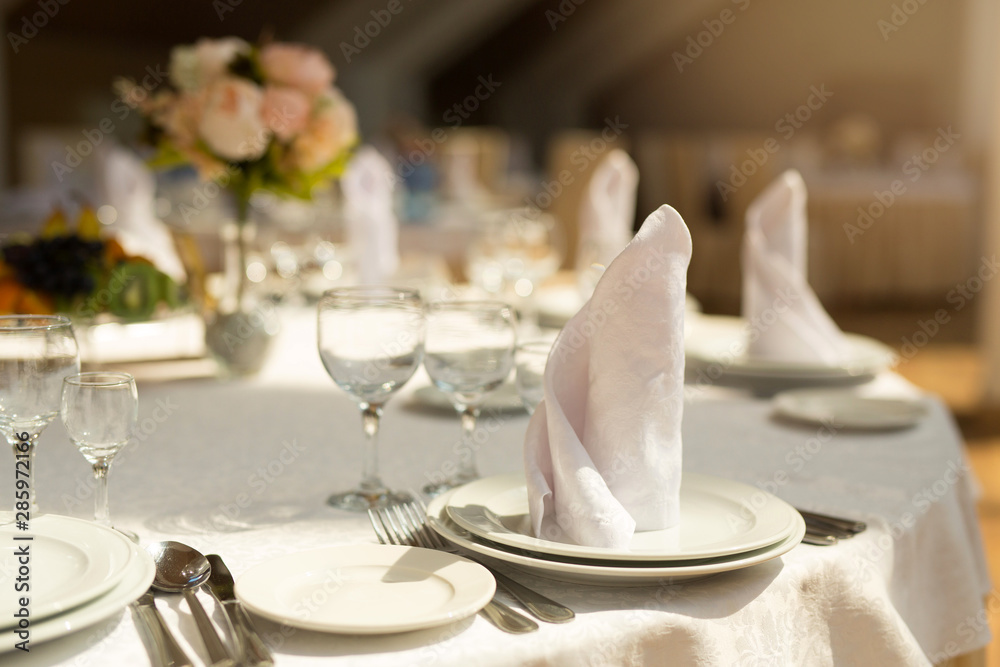 tableware standing on a white festive table tableware standing on a white festive table