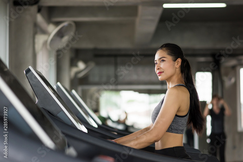 Asian woman run on treadmill in gym