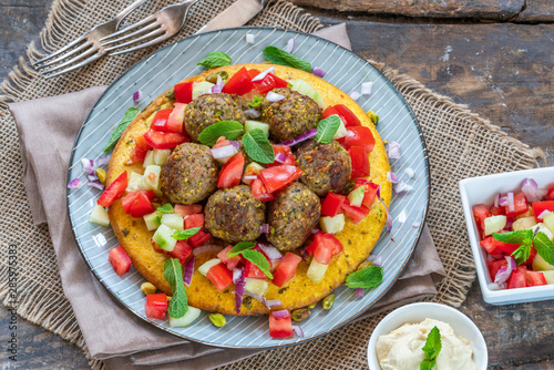 Curried chickpea cake with pistachio lamb meatballs and tomato sambal - overhead view