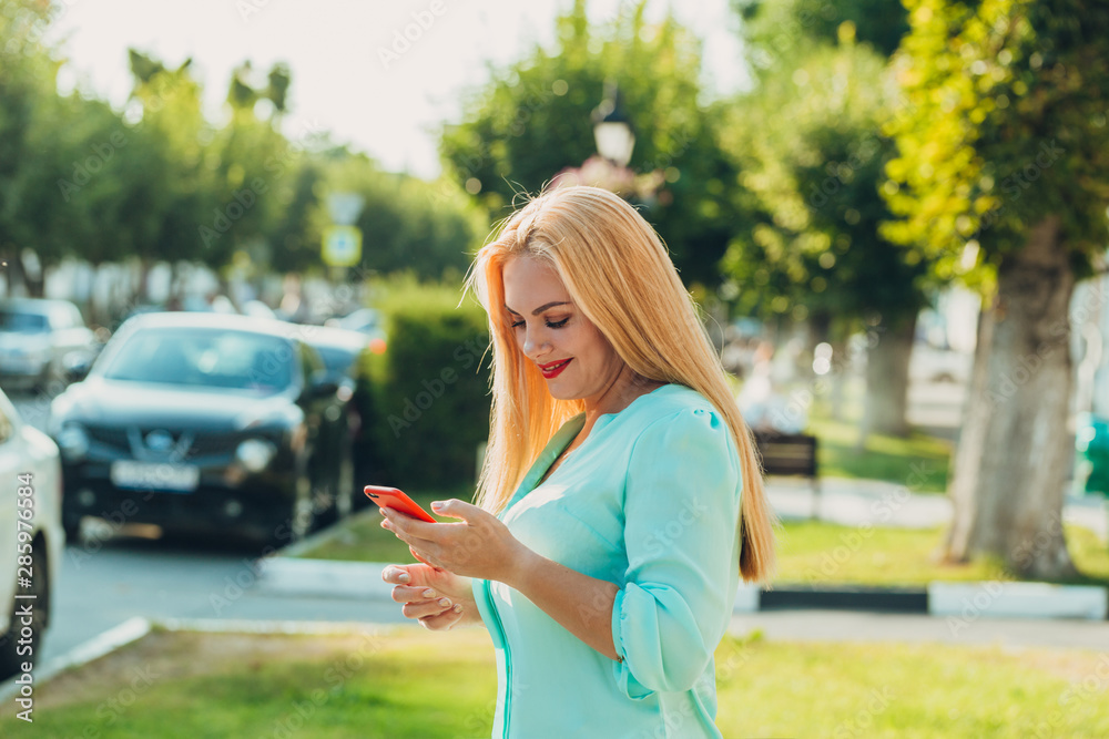 beautiful blonde woman using mobile phone in the city beautiful blonde woman using mobile phone in the city