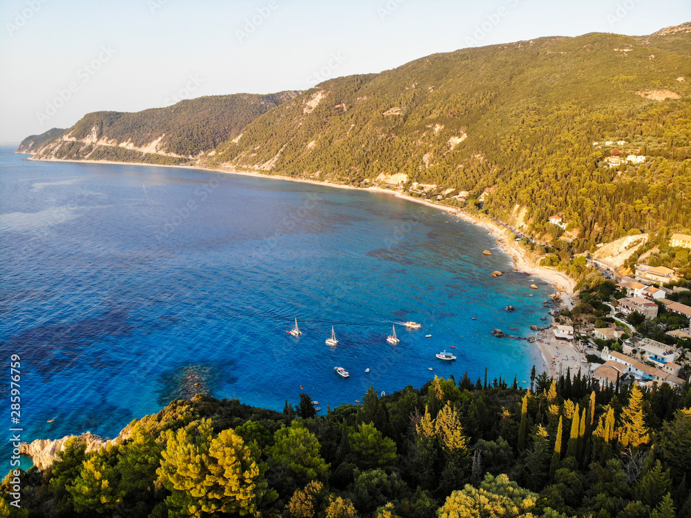 Sea shore with beautiful turquoise blue water by the cliff on Lefkada island in Greece. Aerial view.
