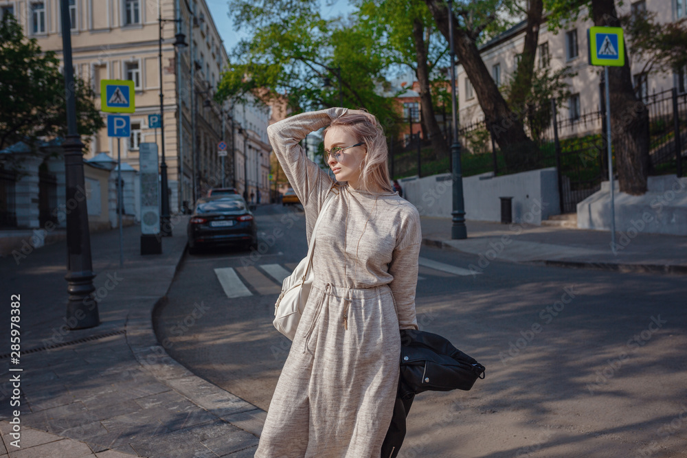Fototapeta premium Beautiful woman walks through the streets of Moscow