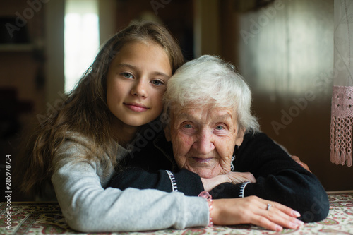 Child of eleven with his grandmother posing for portrait.
