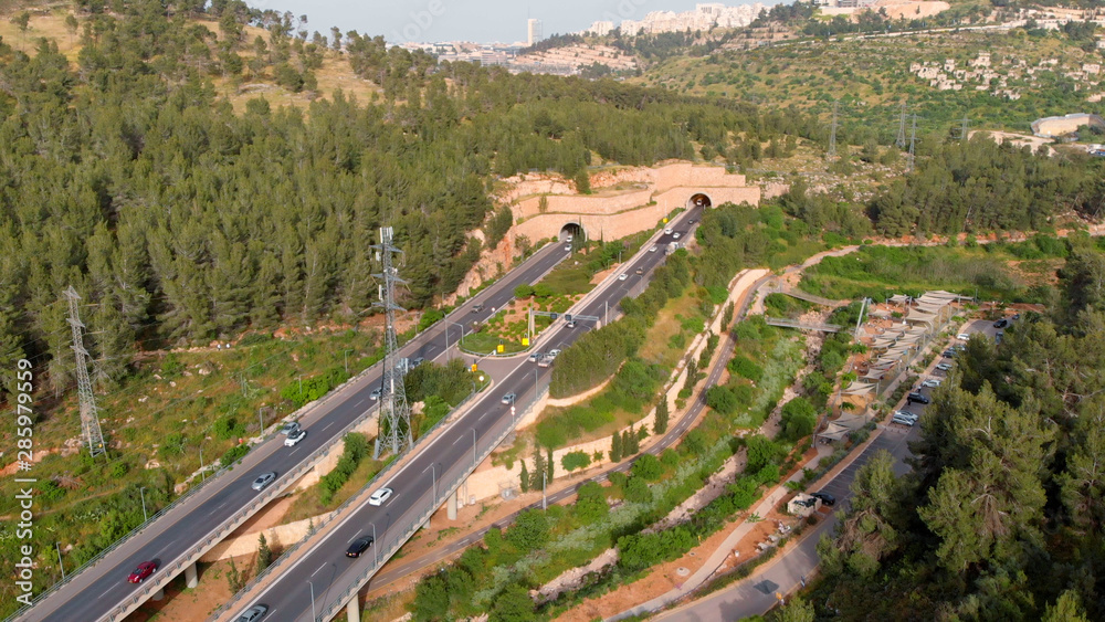 Cars Traffic in tunnels aerial view Flight over Jerusalem traffic cars entering in and out tunnels