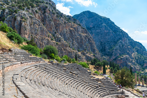 DELPHI / GREECE - JUNE 29, 2019: Ancient theater remains in the archaeological site of Delphi in Greece photo