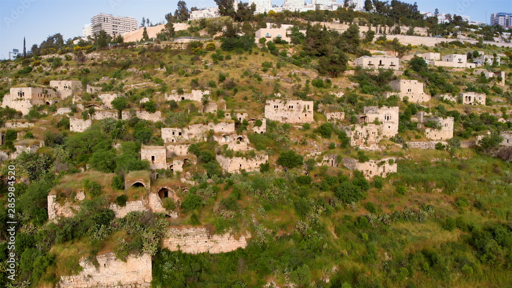 Flying over abandoned Palestinian Lifta Village  Aerial view of Lifta abandoned Palestinian Village with  the main entrance to Jerusalem in the background 