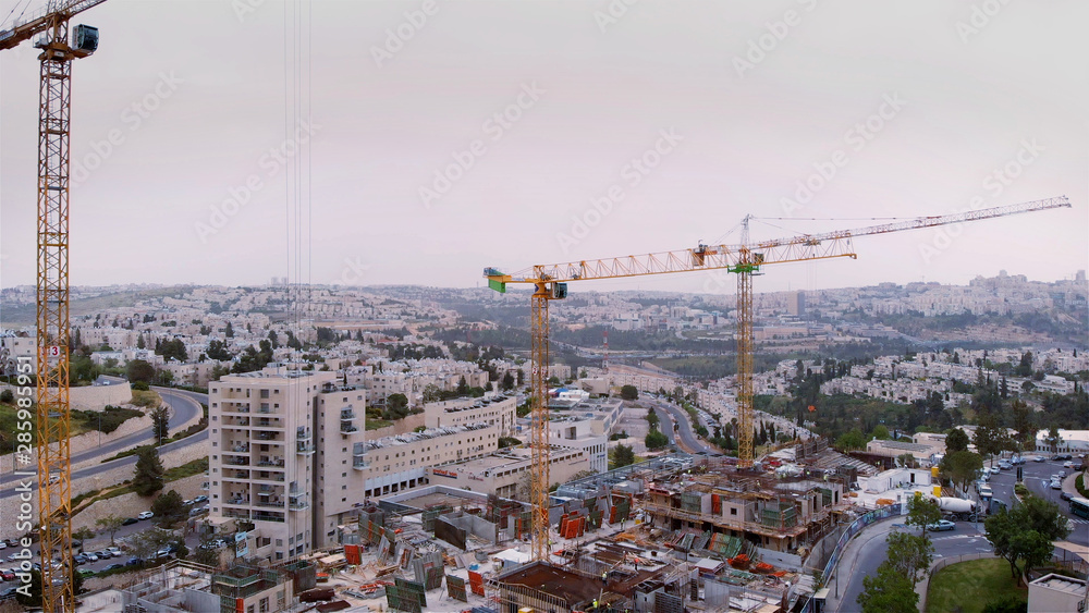 Jerusalem construction site and crane Aerial view Flying over Cranes and construction site in Jerusalem 
