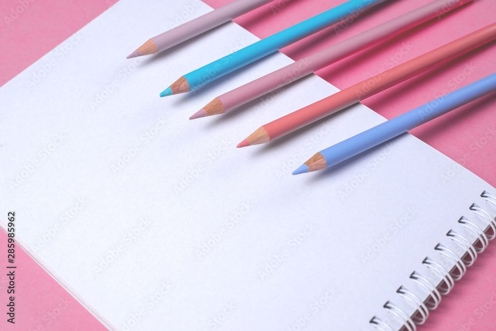 white notebook with pastel pencils white notebook with pastel pencils