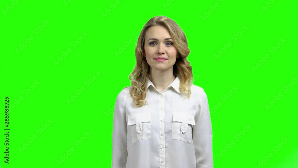 Pretty young woman looking at camera. Young attractive woman in formal shirt on Chroma Key background, front view. Pretty young woman looking at camera. Young attractive woman in formal shirt on Chroma Key background, front view.