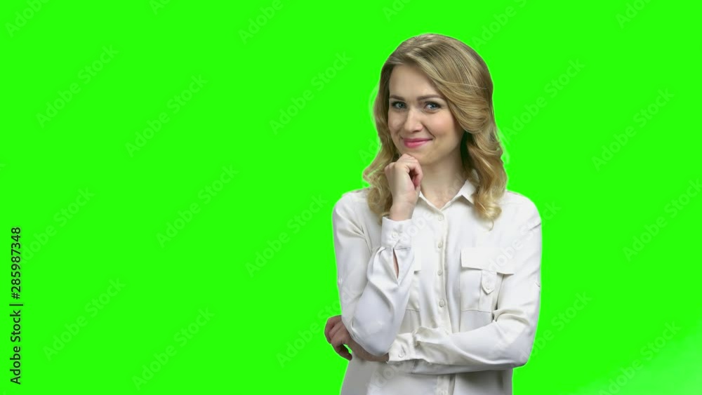 Young surprised woman having an idea. Attractive energetic girl pointing her finger up standing on green screen background. I have got and idea concept.