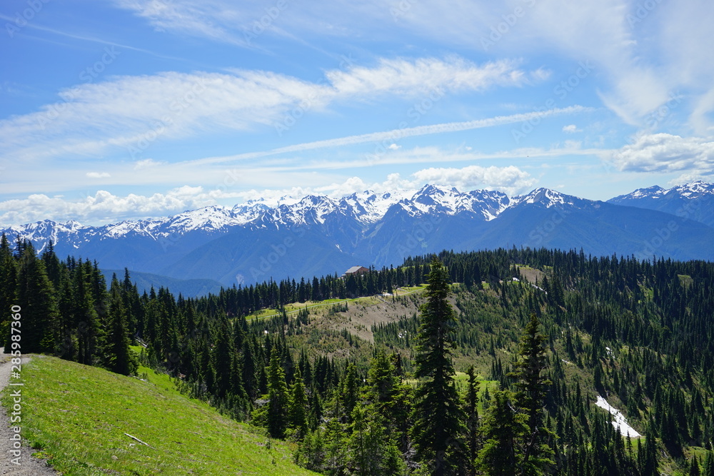 Beautiful cloud over snow capped mountains in Olympic National Park in summer in Washington, near Seattle
