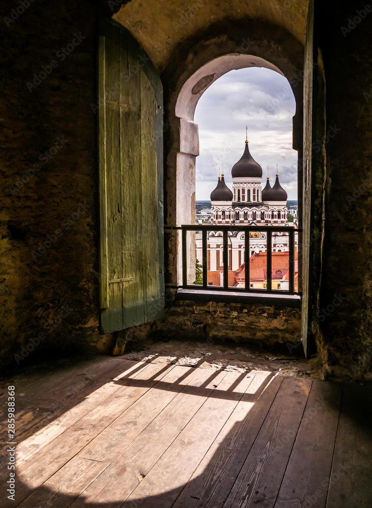 Beautiful Alexander Nevsky Cathedral in Tallinn through the window of St Mary's Cathedral bell tower