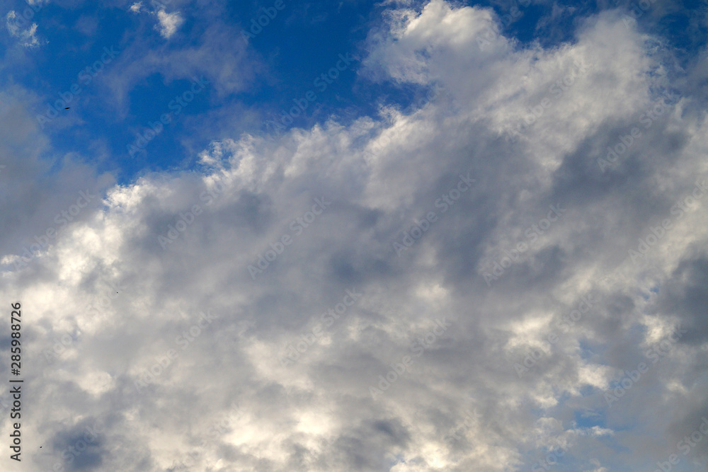 Large white cumulus clouds on a blue sky for background or ecology or nature.