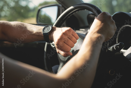 Foto Driver is checking a time on wrist watch on his hand.