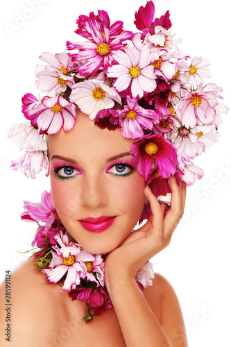 Young beautiful tanned girl with fancy make-up and colorful flowers in her hair © Olga Ekaterincheva