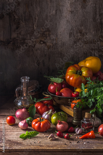 Heirloom tomatoes on dark rustic table, copy space