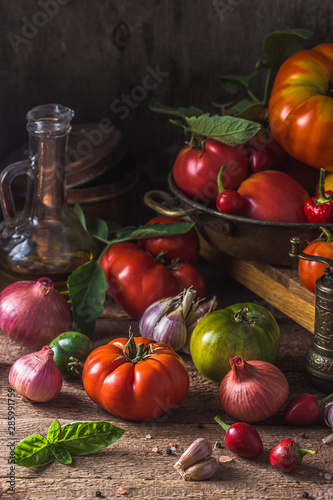 Fototapeta Naklejka Na Ścianę i Meble -  Heirloom tomatoes on dark rustic table, copy space