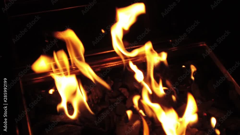 Beautiful flames in charcoal grill. Slow motion at the night.