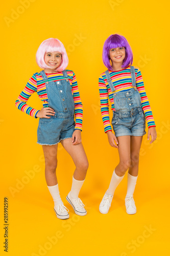 Anime fan. Cheerful friends in colorful wigs. Anime cosplay party concept. Animation style characterized colorful graphics vibrant characters fantastical themes. Anime convention. Happy little girls