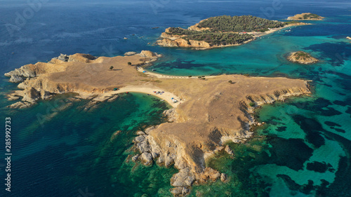 Aerial drone view of paradise small secluded island complex of Drenia and Pena with turquoise and sapphire sea near famous Amouliani island in North Greece, Halkidiki