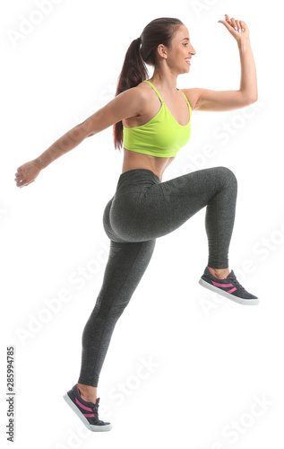 Jumping sporty woman on white background