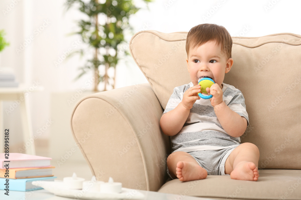 Cute little boy with nibbler sitting on sofa at home Cute little boy with nibbler sitting on sofa at home