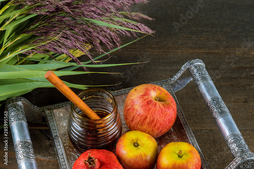 Honey and apples on jewish holiday Rosh Hashanah torah book, kippah a yamolka talit photo