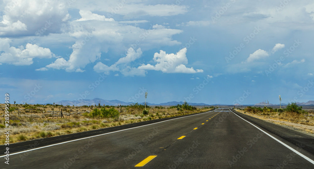 New Mexico highway state route 90, northbound from Lordsburg to Silver City, Gila Mountains in the distance above heat waves on the pavement