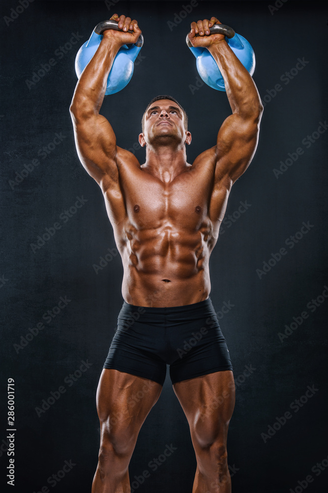 Strong Muscular Men Exercise With Ketllebells