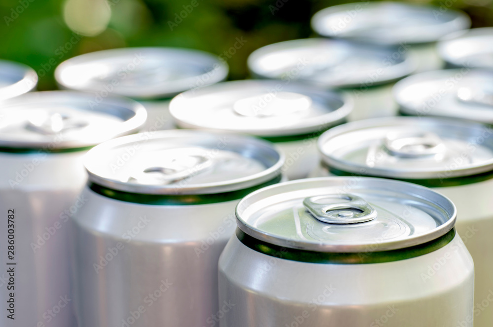 Aluminum closed white cans with beer close-up Aluminum closed white cans with beer close-up
